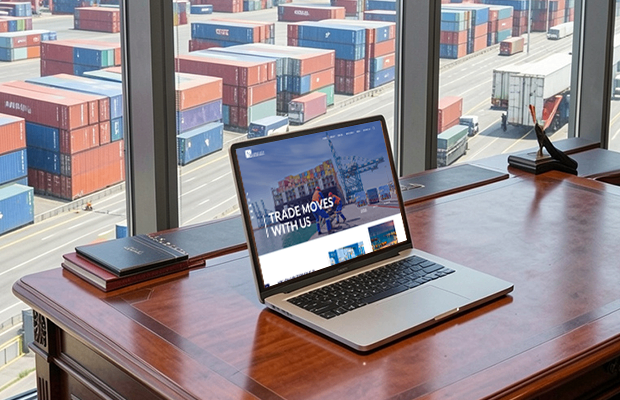 Abu Dhabi Terminals website mockup on a wooden desk overlooking a busy container port with the tagline "Trade Moves With Us